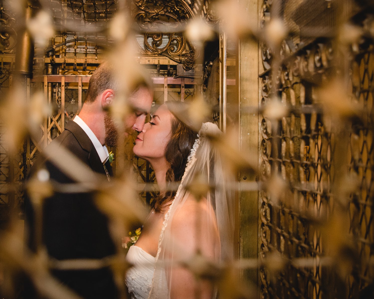 bride and groom in a birdcage elevator