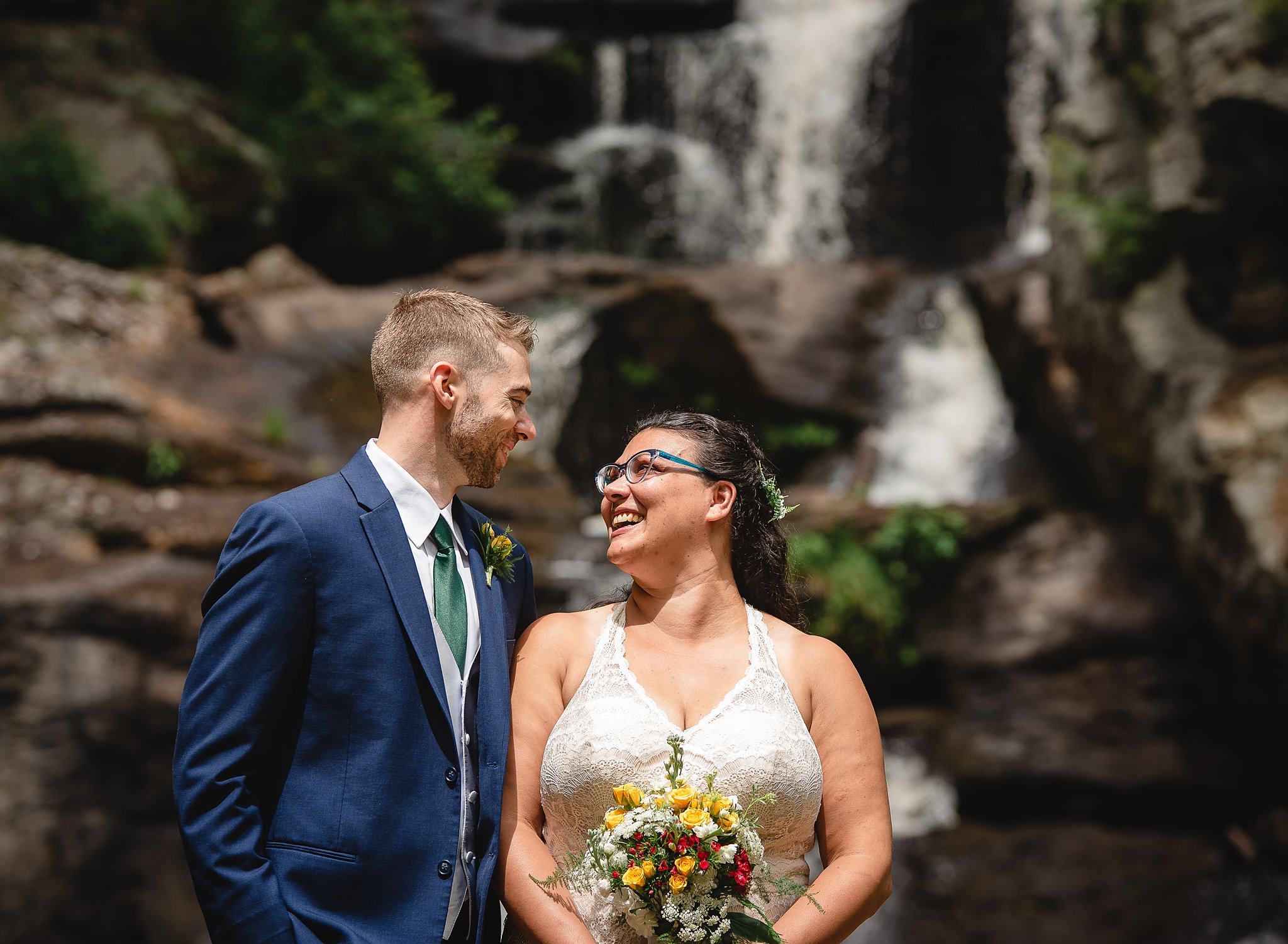 wedding couple in front of waterfall