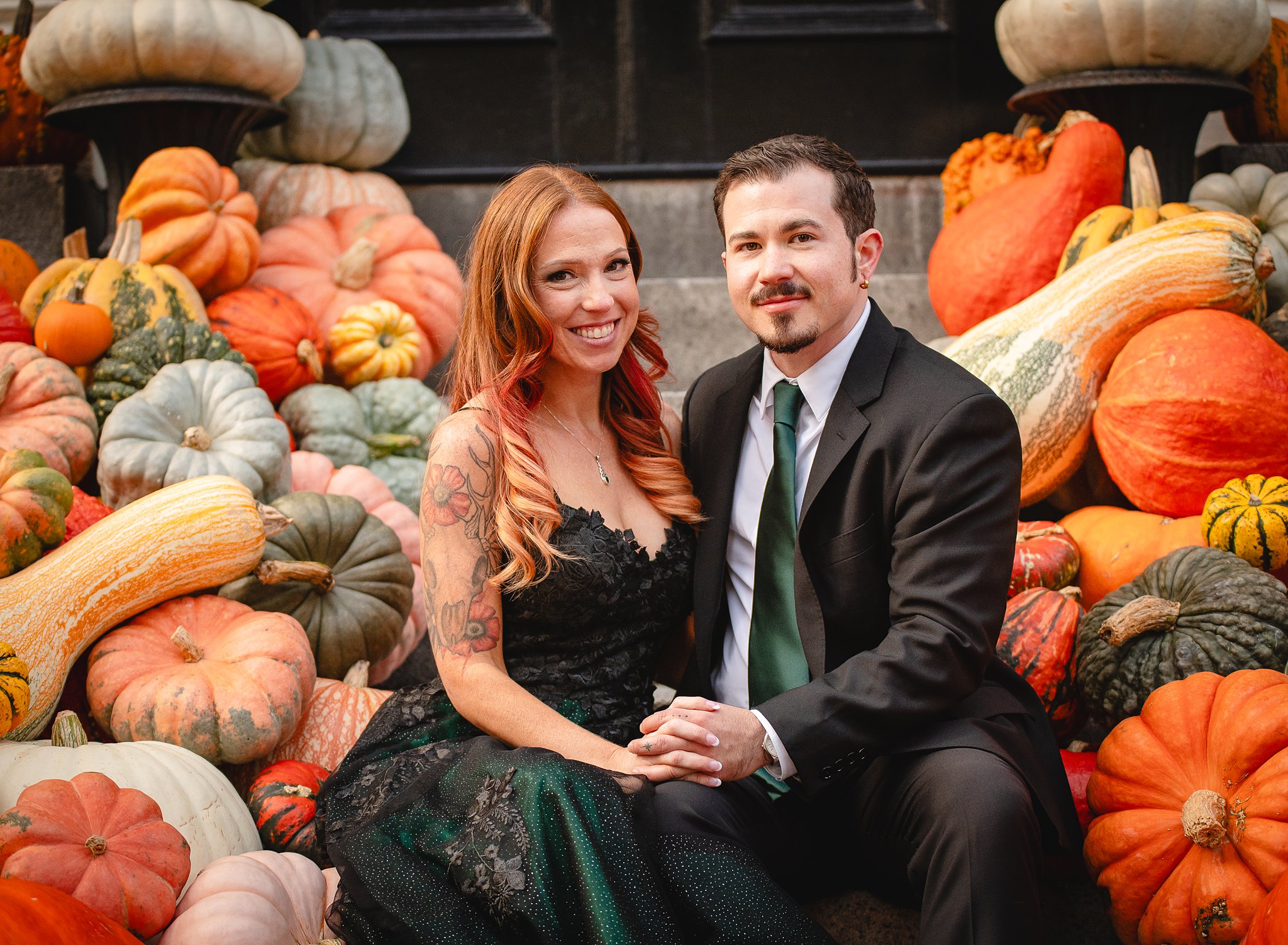 wedding couple posing with pumpkins for their salem massachusetts elopement