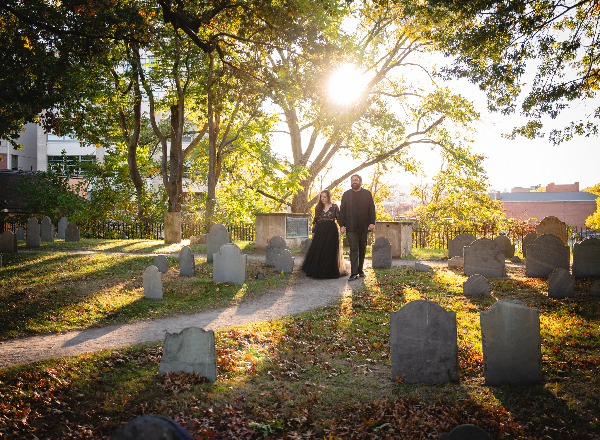 couple walking through a historic cemetery for their Salem elopement